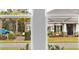 View through a window that overlooks the front of the house and the yard across the street at 2990 Arranmore Dr, Ormond Beach, FL 32174