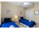 Guest bedroom with twin beds, ceiling fan, and ample closet space at 401 Montara Dr, Davenport, FL 33897