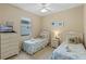 Twin bedroom with two beds, dresser, and ceiling fan at 401 Montara Dr, Davenport, FL 33897