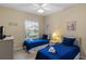 Twin bedroom with two beds, plenty of natural light and ceiling fan at 401 Montara Dr, Davenport, FL 33897