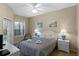 Main bedroom with a king bed, ceiling fan, and access to patio at 401 Montara Dr, Davenport, FL 33897