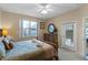 Bright bedroom with king bed, dresser, and private access to the pool at 401 Montara Dr, Davenport, FL 33897