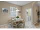 Cozy breakfast nook with a round table and four chairs, adjacent to laundry at 401 Montara Dr, Davenport, FL 33897