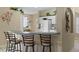 Kitchen features a breakfast bar with seating for three and white cabinetry at 401 Montara Dr, Davenport, FL 33897