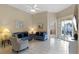 Spacious living area with two sofas, tiled floors, and access to the backyard pool at 401 Montara Dr, Davenport, FL 33897
