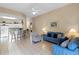 Open living room with tile floors, comfy sofas, and views of the kitchen and pool at 401 Montara Dr, Davenport, FL 33897