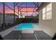 Relaxing pool with patio furniture under sunset at 401 Montara Dr, Davenport, FL 33897