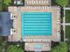 Community lap pool and hot tub with lounge chairs at 4712 Anson Ln, Orlando, FL 32814