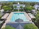 Community lap pool with lounge chairs and clubhouse at 4712 Anson Ln, Orlando, FL 32814
