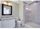 Bathroom with granite countertop, white cabinets, and a large shower at 4712 Anson Ln, Orlando, FL 32814