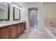 Elegant bathroom with double vanity and soaking tub at 4712 Anson Ln, Orlando, FL 32814
