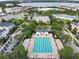 Aerial view of community pool with surrounding lounge chairs and landscaping at 4712 Anson Ln, Orlando, FL 32814