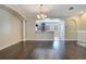 Open dining room with hardwood floors and a view into the kitchen at 4712 Anson Ln, Orlando, FL 32814