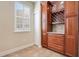 Kitchen pantry with wine rack and ample wood cabinetry at 4712 Anson Ln, Orlando, FL 32814