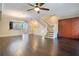 Spacious living room with dark hardwood floors and a staircase to the second floor at 4712 Anson Ln, Orlando, FL 32814