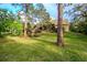Spacious backyard with lush landscaping and large trees at 6408 Shoreline Ct, St Cloud, FL 34771