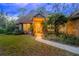 Inviting home exterior featuring a landscaped yard and charming porch at 6408 Shoreline Ct, St Cloud, FL 34771