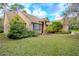 Tan house with a covered entryway and well-manicured lawn at 6408 Shoreline Ct, St Cloud, FL 34771
