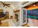 Cozy living room with fireplace and access to a screened porch at 6408 Shoreline Ct, St Cloud, FL 34771