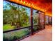 Peaceful screened porch with string lights and backyard view at 6408 Shoreline Ct, St Cloud, FL 34771