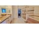 Bathroom features tiled walk-in shower and soaking tub with separate vanities at 6408 Shoreline Ct, St Cloud, FL 34771