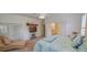 Carpeted primary suite with balcony access, television, and private bath at 6408 Shoreline Ct, St Cloud, FL 34771