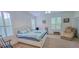 Comfortable carpeted bedroom features large windows and cozy chaise lounge at 6408 Shoreline Ct, St Cloud, FL 34771