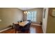 Dining room showcases wood floors, a chandelier, and shuttered windows at 6408 Shoreline Ct, St Cloud, FL 34771