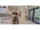 Kitchen featuring bar seating opens to living area and screened-in lanai at 6408 Shoreline Ct, St Cloud, FL 34771