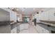 Bright kitchen featuring white cabinets, and grey countertops at 6408 Shoreline Ct, St Cloud, FL 34771