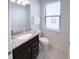 Well-lit bathroom featuring granite counters, modern fixtures, and a window at 8956 Zurich Ln, Kissimmee, FL 34747