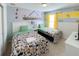 Whimsical ' bedroom with twin beds, a window, and a Minions themed mural at 8956 Zurich Ln, Kissimmee, FL 34747