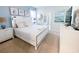 Bright bedroom featuring a queen bed, beach-themed art, and ensuite bathroom at 8956 Zurich Ln, Kissimmee, FL 34747