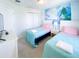 bedroom with twin beds, a TV, and a large cartoon mural at 8956 Zurich Ln, Kissimmee, FL 34747