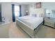Cozy bedroom with a queen bed, TV, and soft gray walls at 8956 Zurich Ln, Kissimmee, FL 34747
