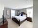 Inviting primary bedroom featuring an upholstered bed frame, TV, and a calm gray color palette at 8956 Zurich Ln, Kissimmee, FL 34747