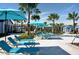 Expansive pool deck with vibrant blue lounge chairs and umbrellas, ideal for enjoying sunny days at 8956 Zurich Ln, Kissimmee, FL 34747