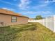 Private backyard with grassy area and white fence at 9564 Venezia Plantation Dr, Orlando, FL 32829