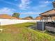 Large backyard with a privacy fence and air conditioning unit at 9564 Venezia Plantation Dr, Orlando, FL 32829