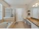 Bathroom with soaking tub, shower, and granite countertops at 9564 Venezia Plantation Dr, Orlando, FL 32829