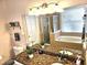 Bathroom with granite vanity, soaking tub, and walk-in shower at 9564 Venezia Plantation Dr, Orlando, FL 32829