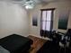 Bright bedroom with wood floors, ceiling fan, and window coverings at 9564 Venezia Plantation Dr, Orlando, FL 32829