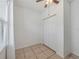 Simple bedroom with double door closet and tile floors at 9564 Venezia Plantation Dr, Orlando, FL 32829