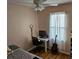 Bedroom with a guitar, desk, and ceiling fan at 9564 Venezia Plantation Dr, Orlando, FL 32829