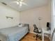 Cozy bedroom featuring a desk, chair, and ceiling fan at 9564 Venezia Plantation Dr, Orlando, FL 32829