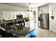 Kitchen boasts granite countertops, stainless steel appliances, and an island at 9564 Venezia Plantation Dr, Orlando, FL 32829