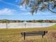 Tranquil lake view with bench and fountain at 9564 Venezia Plantation Dr, Orlando, FL 32829