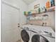 Laundry room with Samsung washer and dryer, and shelving at 9564 Venezia Plantation Dr, Orlando, FL 32829