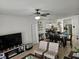 Open concept living room and kitchen with ample natural light at 9564 Venezia Plantation Dr, Orlando, FL 32829
