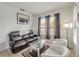 Living room with leather couch, glass coffee table, and two armchairs at 9564 Venezia Plantation Dr, Orlando, FL 32829